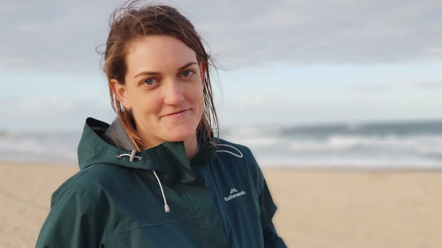 Ellie Knock stands on a beach