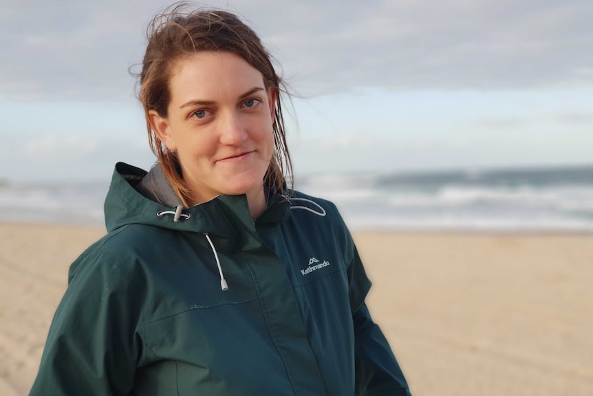 Ellie Knock stands on a beach