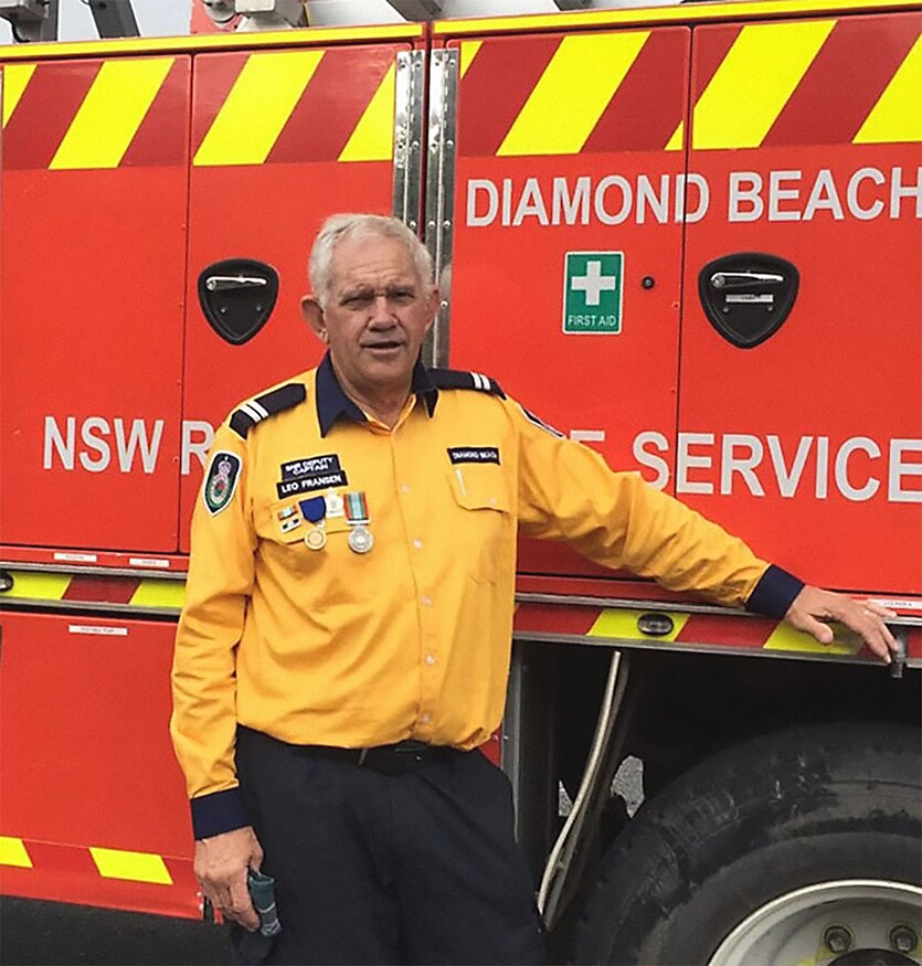 A man stands next to a fire truck