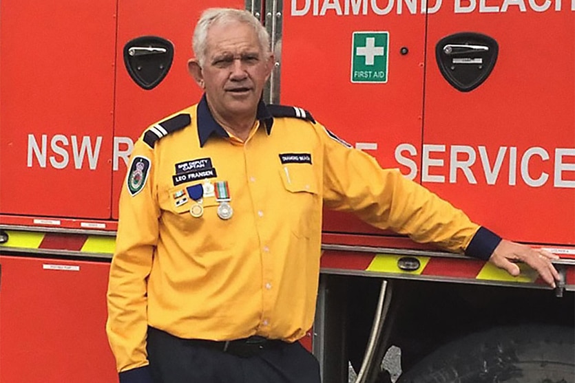 A man stands next to a fire truck