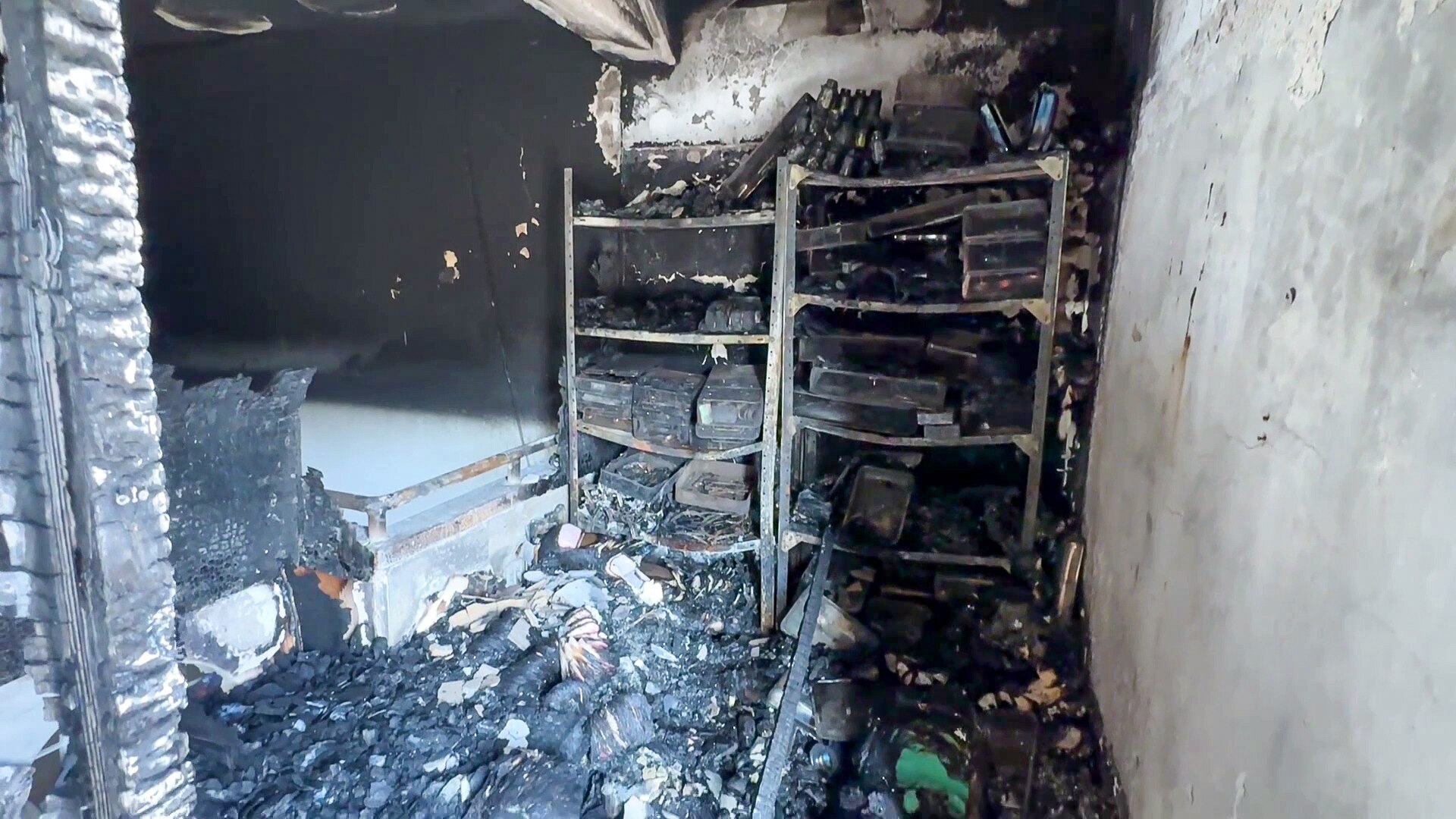The charred remains of shelves of burned medicine sitting inside Kamal Adwan hospital.