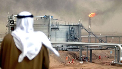 An employee of the Kuwait Oil Company looks at a Gathering Centre at the al-Rawdatain field, 100 kms north of Kuwait City, Ja...