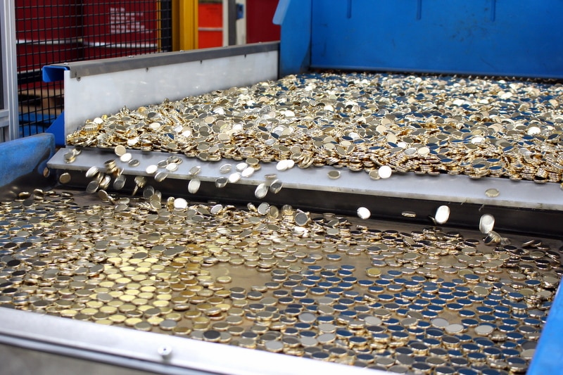 Two dollar coins on the way to be stamped at the Royal Australian Mint.