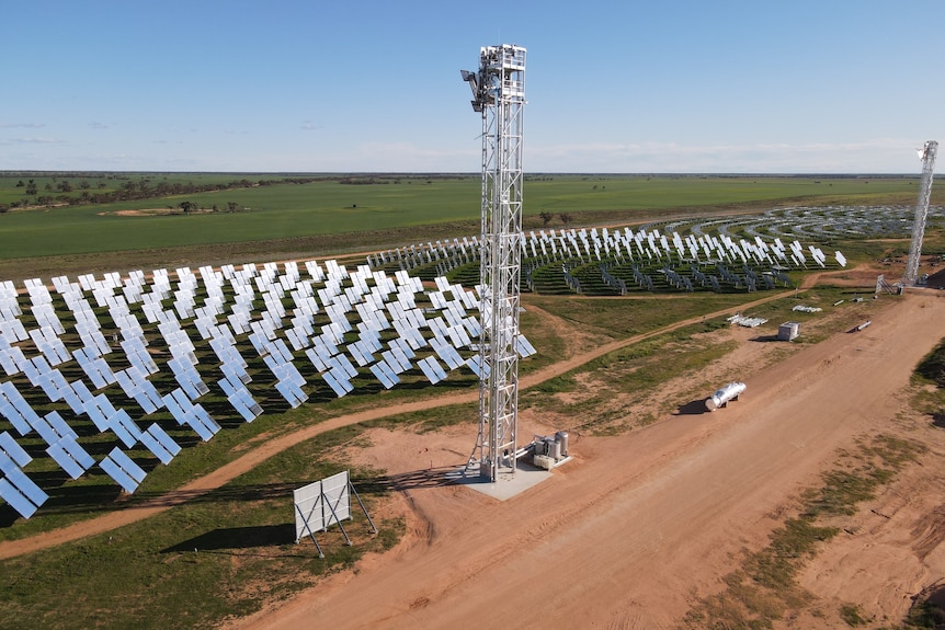 Aerial image looking at array of mirrors arranged in a semi-circle to face a tower