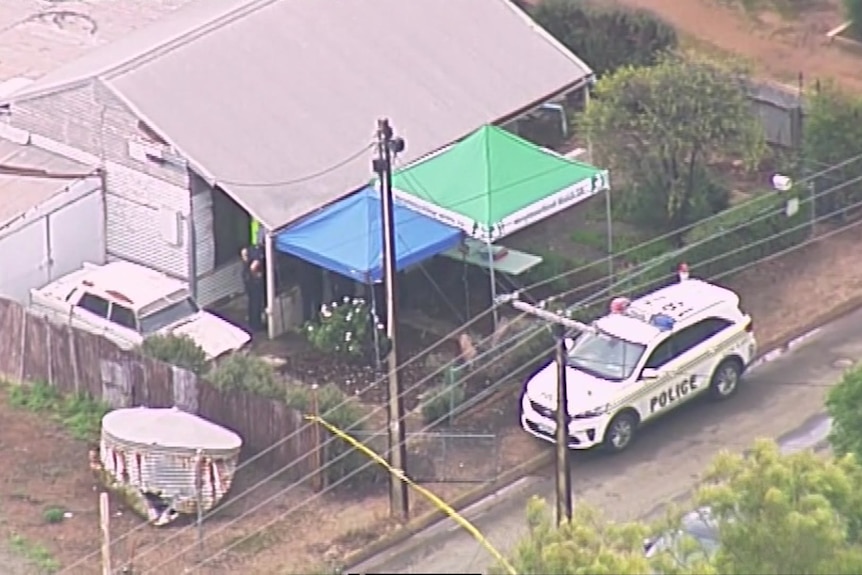 A police car sits outside a house.