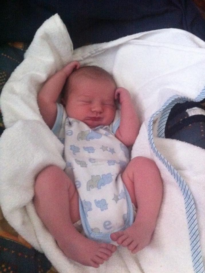 Baby Michael Smedley as a newborn lies sleeping.