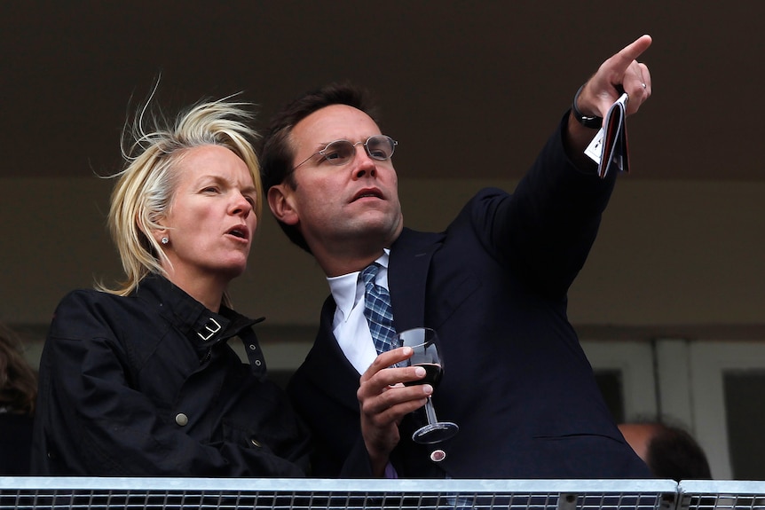 James Murdoch pointing something out to Elisabeth Murdoch