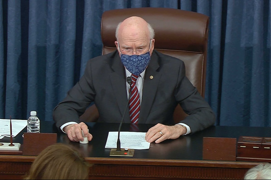 Senator Patrick Leahy sits in the Senate president's chair as article of impeachment are produced