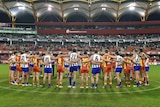 Suns and Kangaroos huddle at centre circle to pay tribute to Phil Walsh