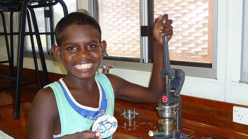 A Mornington Island State School student making a totem badge.