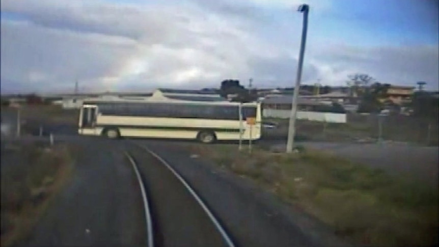 A school bus crosses a level crossing