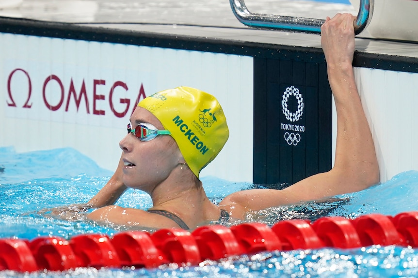 An Australian female swimmer looks back at the scoreboard after finishing a heat at the Tokyo Olympics.