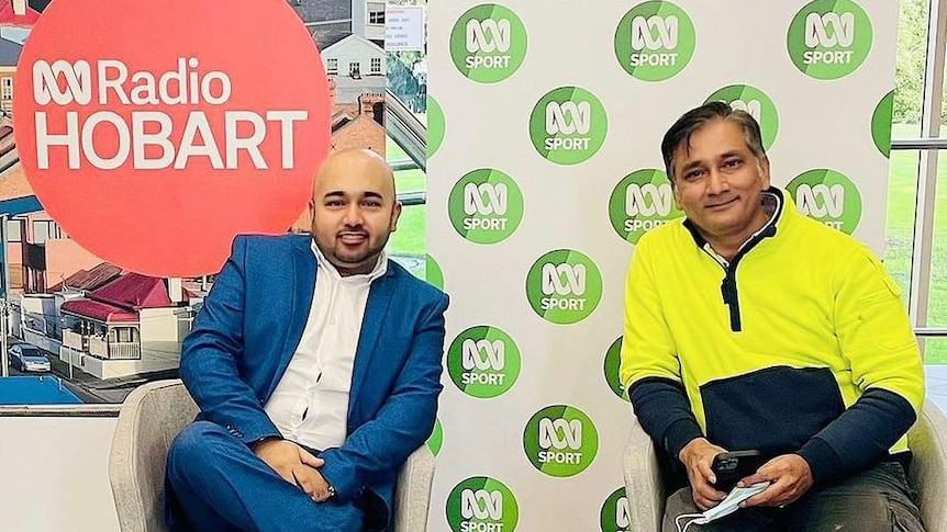 Two men sit comfortably together outside ABC Radio Hobart studio