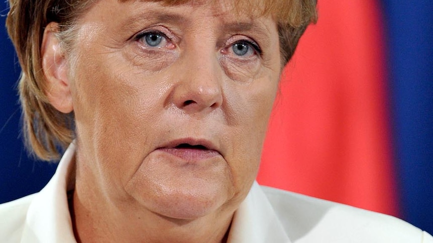 Angela Merkel talks and gestures during a press conference