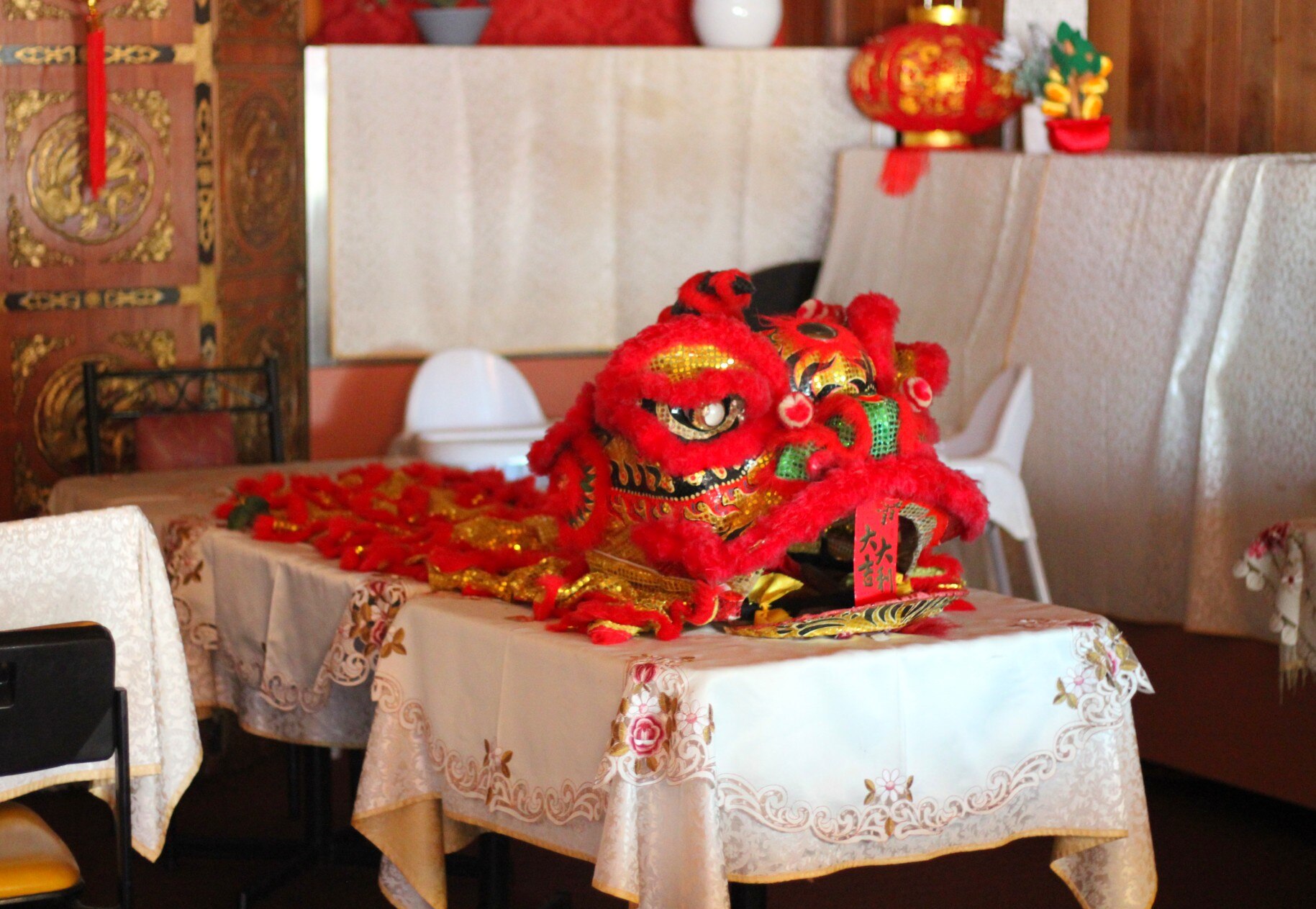A red Chinese dragon on a table in a Chinese restaurant