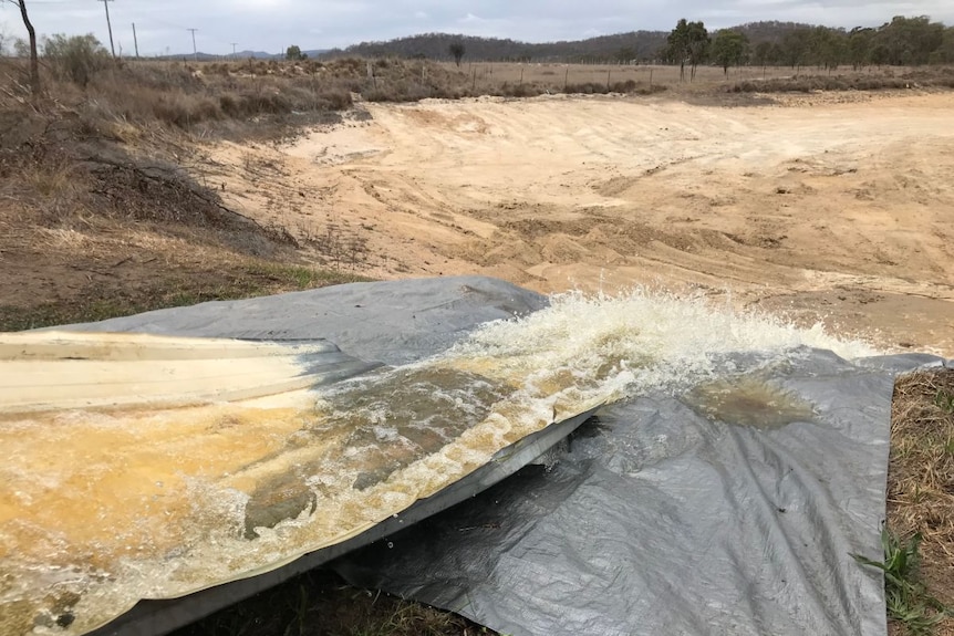 Water running down a ramp to be trucked to a vineyard.