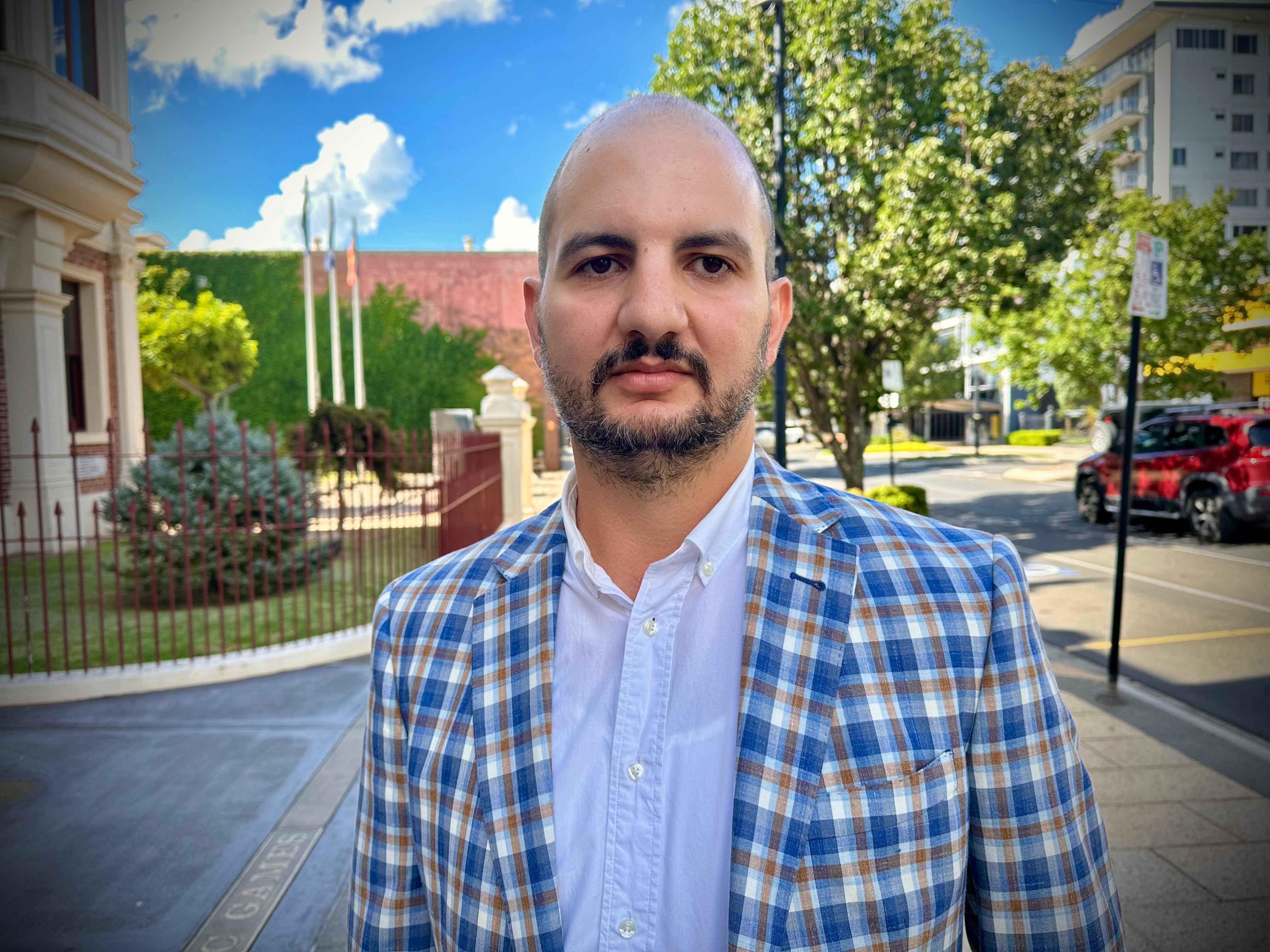 A man looks at a camera