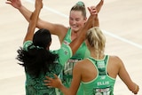 Alice Teague-Neeld hugs some teammates in the middle of the court