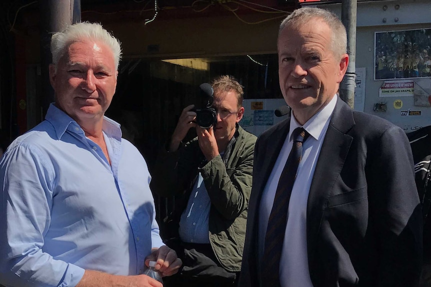 Jim Ward and Bill Shorten stand together at Longford