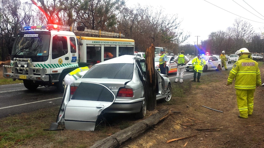 Emergency services officers attend the scene of an car accident at Gwandalan.