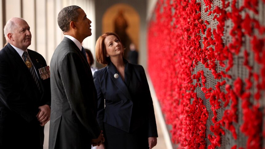 Barack Obama looks at the Roll of Honour after laying a wreath at the Australian War Memorial.