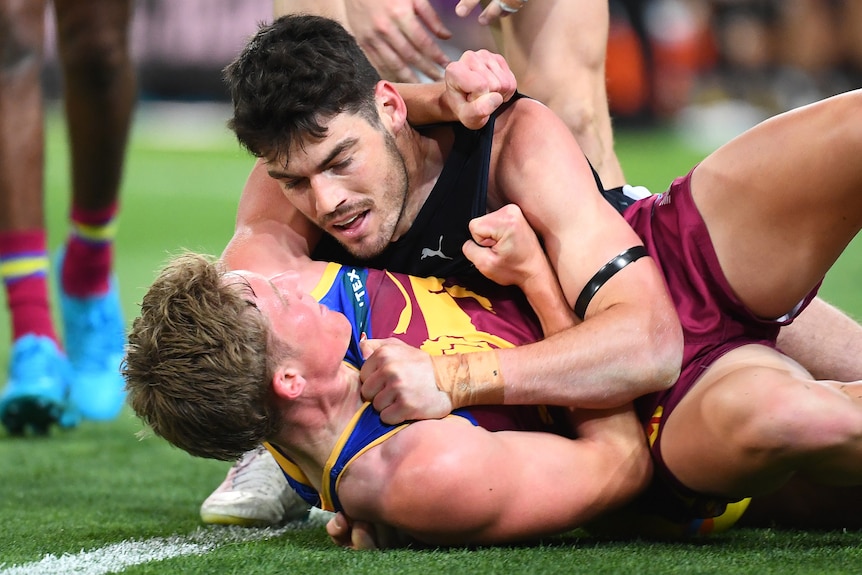 jaspa fletcher and george hewett in a scuffle on the football field