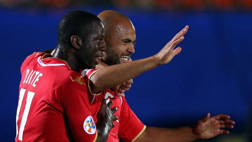 Adelaide's Sergio van Dijk and Bruce Djite celebrate a goal in the AFC Champions League.