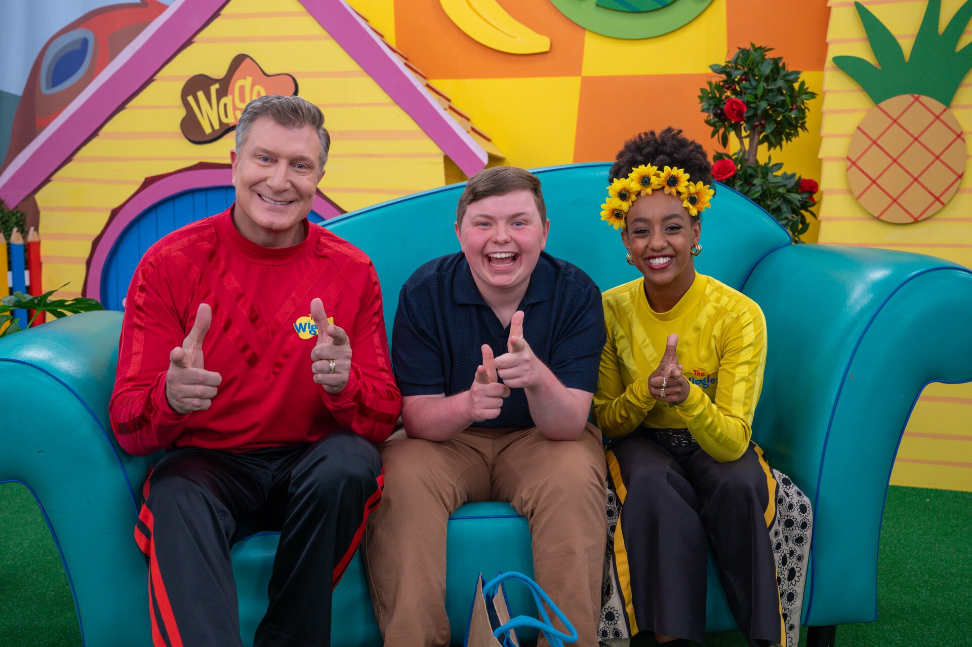 Fletcher from The Assembly on the set of the Wiggles with the red Wiggle Simon Pryce and Yellow Wiggle Tsehay Hawkins. 