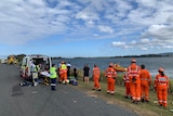 SES and paramedics standing on the bank of the Richmond River in South Ballina.