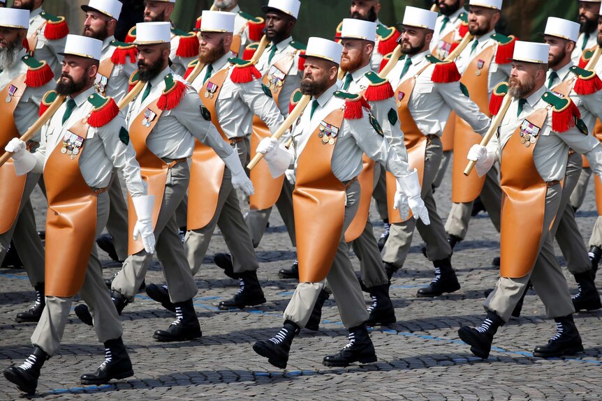 Pioneers of the 1st Foreign Legion regiment carry their axes as they march during the traditional Bastille Day military parade.