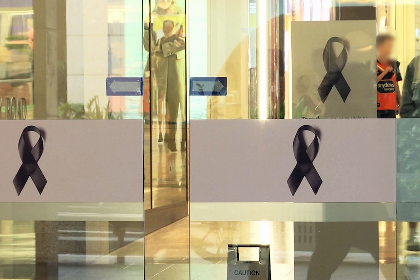 black ribbons adorn the inside westfield bondi junction to honour lives lost and ijured in stabbing attack on 130424