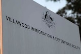 a sign that reads villawood immigration and detention facility