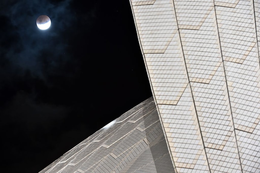 Lunar eclipse moon next to the Sydney Opera House 