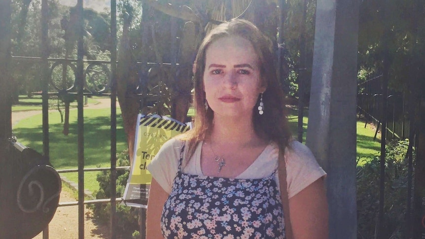 Triona Mullahy standing in front of a gate outdoors.