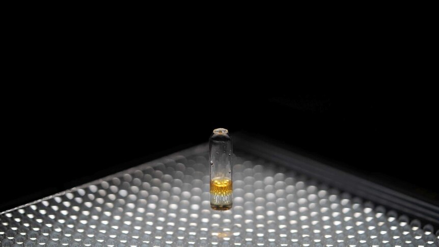 a yellow substance in small vial.
