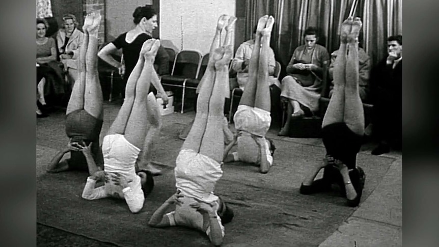 Old photo of women doing yoga in class