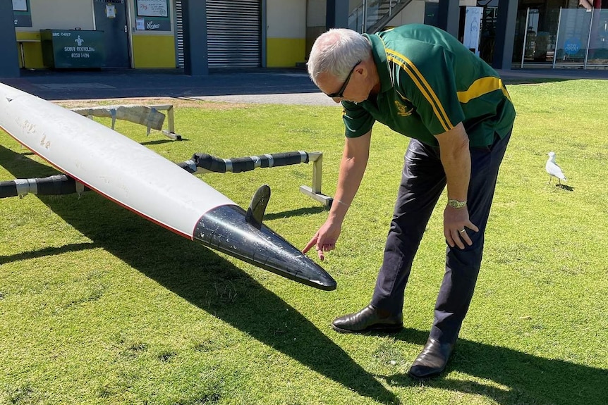 A man points at a surf ski.