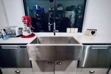 a large kitchen sink with a window above it