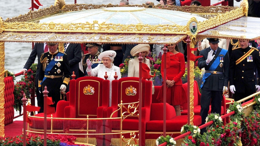 The Queen waves from the royal barge during the Thames Diamond Jubilee Pageant.