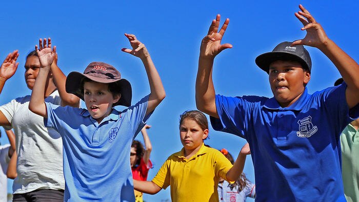 Indigenous children dance.
