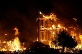 Photo shows a building in flames at night 