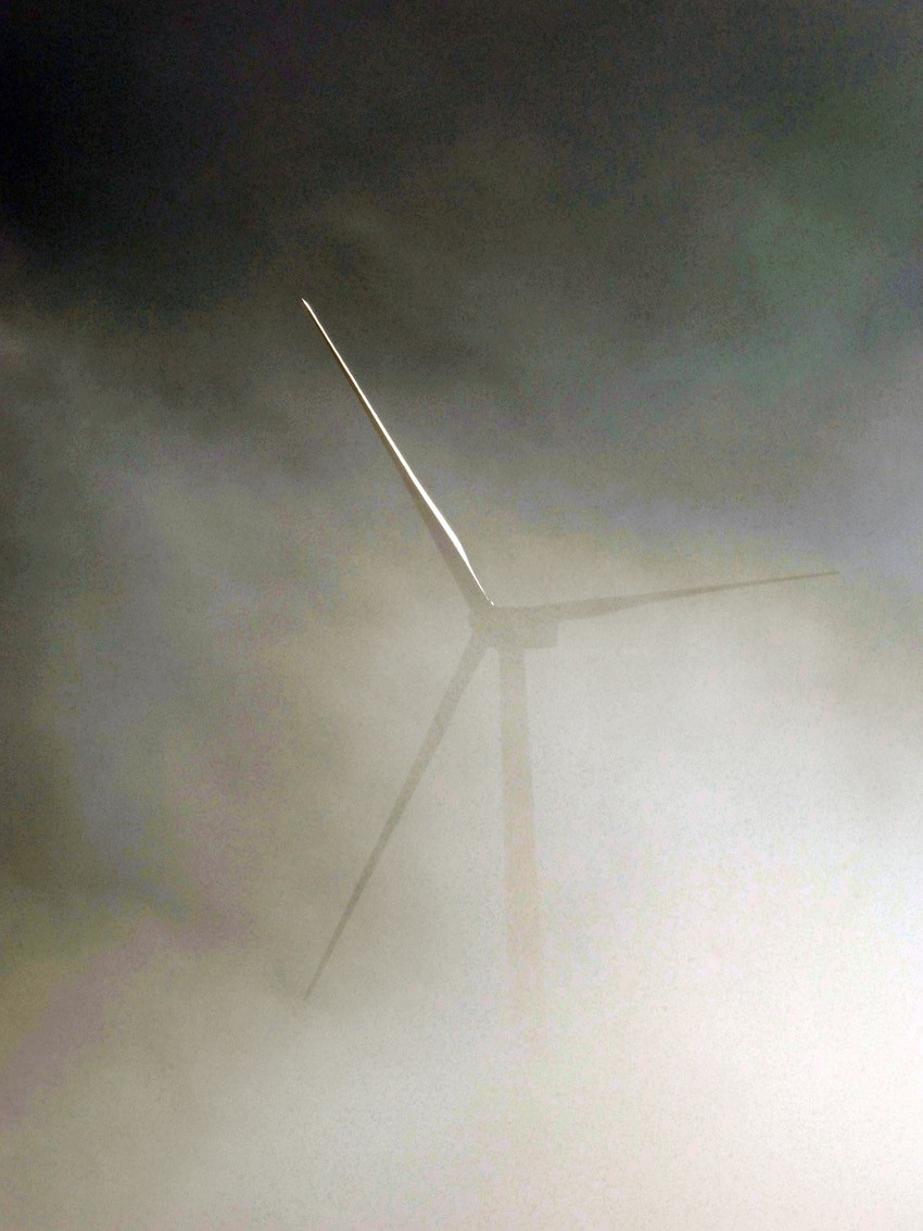 A wind turbine in the mist