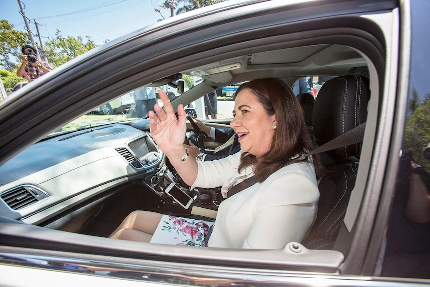 Queensland Premier Annastacia Palaszczuk waves from the car as she arrives at Government House in Brisbane, on October 29, 2017