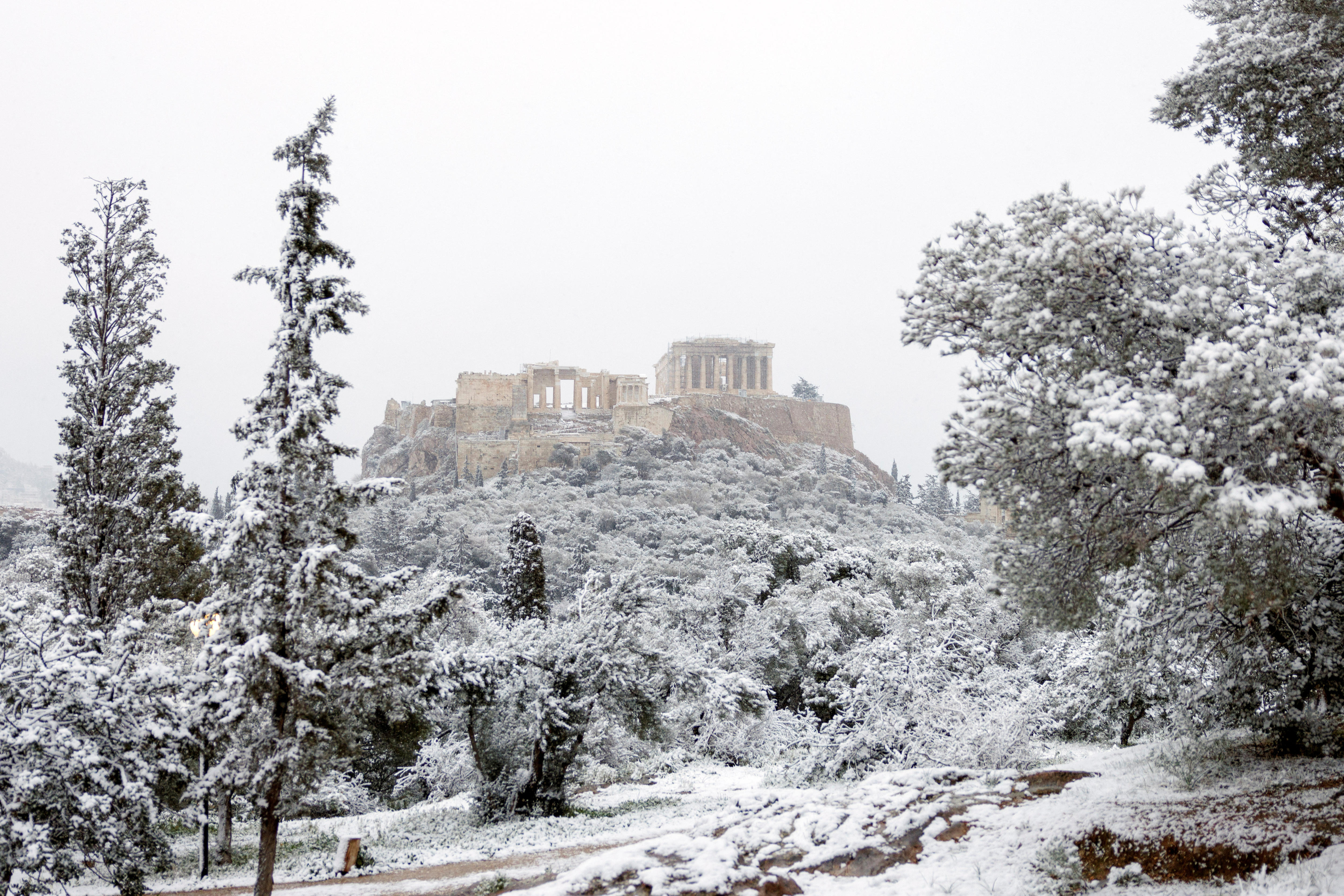 Acropolis dusted in snow as winter storm shuts schools and shops, disrupts traffic in Athens
