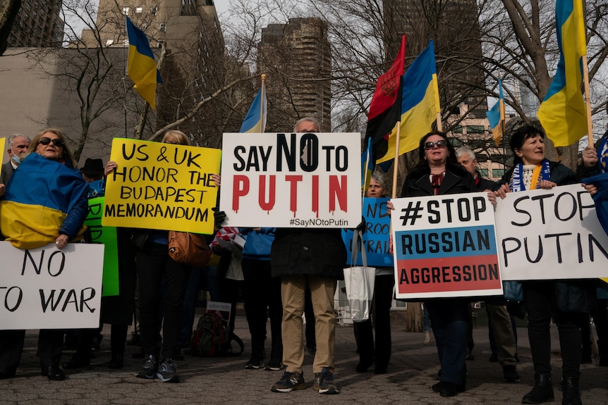 A group of protestors hold signs in support of Ukraine outside of UN headquarters in New 