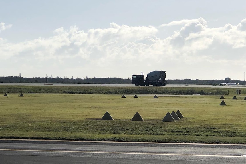 A truck driving on the tarmac