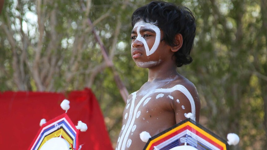 A young Indigenous Australian boy in body paint