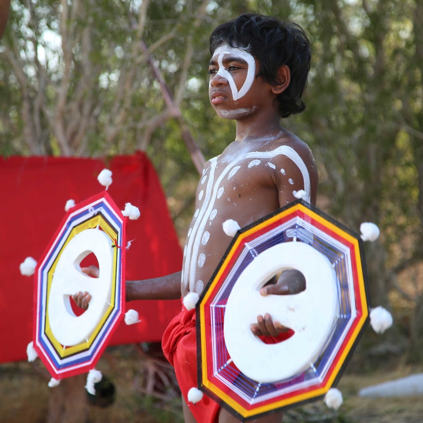 A young Indigenous Australian boy in body paint