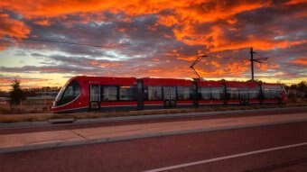 Light rail against the sunset.