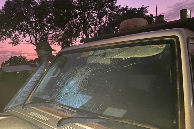 The front windscreen of a police vehicle with a large glass shatter in the middle.